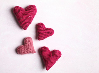 Crochet hearts on pink background. Valentine's Day concept