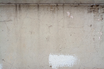 Cracked concrete wall with paint residues