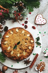 Homemade Christmas fruitcake on festive Xmas holiday background