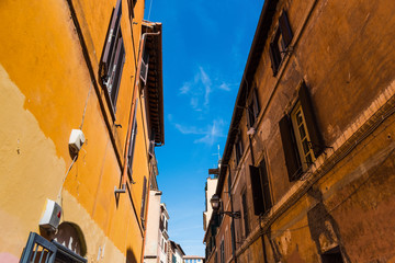 Fototapeta na wymiar Old facades in a narrow alley in Rome