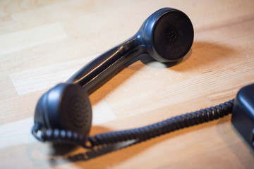 alter Telefonhörer auf Holztisch