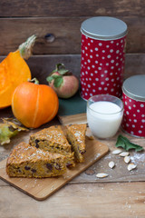 Pumpkin pie with milk on wooden cutting board