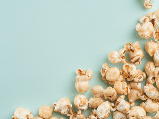 popcorn on blue background. Movie background with copy space. Top view or flat lay.