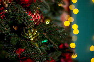 Obraz na płótnie Canvas decorated Christmas tree close-up, New Year's scenery, lights in the background