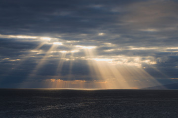 Sun rays are shining through the clouds