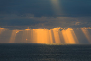 Sun rays are shining through the clouds