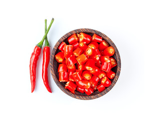 slice red chili in wood bowl isolated on white background.top view