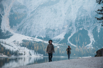 Hipsters walk through the Mountain Lake Cold Beach