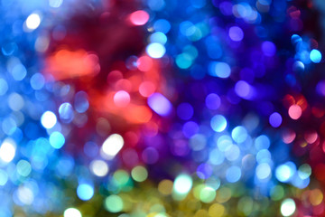 Fototapeta na wymiar Bokeh. Holiday background. Christmas lights. Glitter. Defocused sparkles. New Year backdrop. Festive wallpaper. Blinks. Carnival. Tinsel. Bokeh retro style photo.