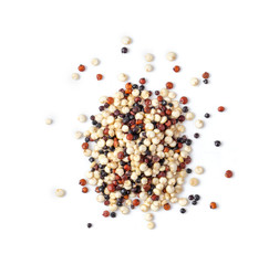 Pile of mixed raw quinoa isolated on white background. top view