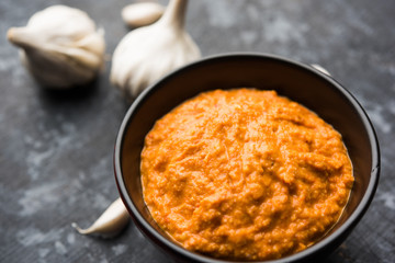 Garlic chutney, made using lahsun/lehsun originating from the India, served in a bowl over moody background. selective focus