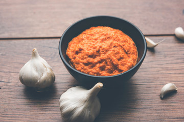 Garlic chutney, made using lahsun/lehsun originating from the India, served in a bowl over moody background. selective focus