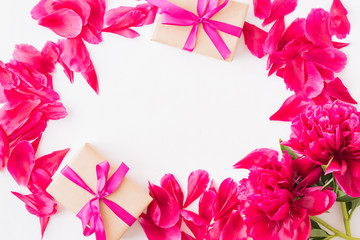 Fototapeta na wymiar Valentines day composition with red peonies and gift box on a light background