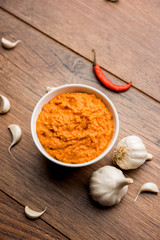 Garlic chutney, made using lahsun/lehsun originating from the India, served in a bowl over moody background. selective focus