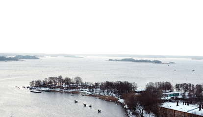 Peninsula in winter in the middle of the Bay on the background of other Islands