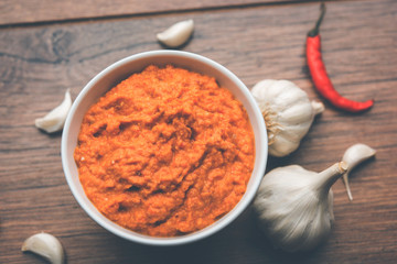 Garlic chutney, made using lahsun/lehsun originating from the India, served in a bowl over moody background. selective focus