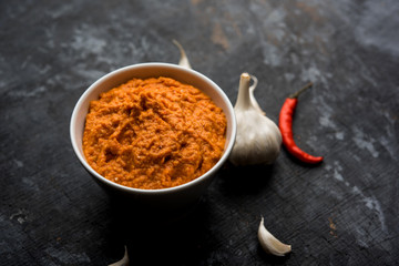 Garlic chutney, made using lahsun/lehsun originating from the India, served in a bowl over moody background. selective focus