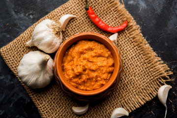 Garlic chutney, made using lahsun/lehsun originating from the India, served in a bowl over moody background. selective focus