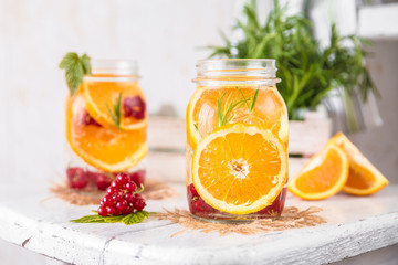 Cold Fruit Infused Detox Water with orange red currants and rosemary
