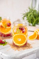 Cold Fruit Infused Detox Water with orange red currants and rosemary