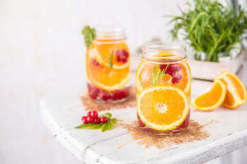 Cold Fruit Infused Detox Water with orange red currants and rosemary