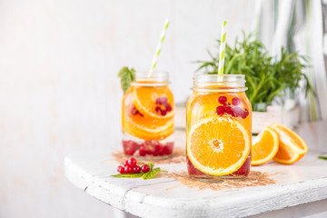 Cold Fruit Infused Detox Water with orange red currants and rosemary