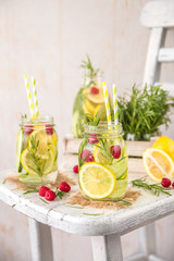 Fototapeta na wymiar Cold Fruit Infused Detox Water with lemon, cucumber, raspberry and rosemary