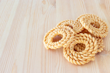 Chakli or Murukku popular vegetarian snack South India. Spiral shaped crisp deep-fried snack. Close up.. Selective focus. Copy space.