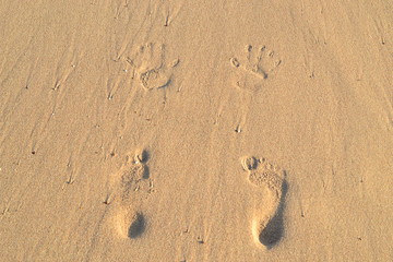 Imprint your feet on the sand. Footprints in the sand