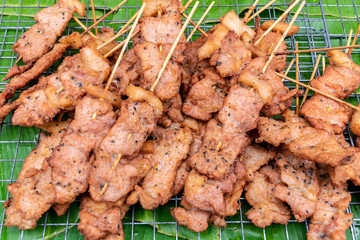 Fried Pork stick on grid market, Thai cuisine traditional signature street food (selective focus)
