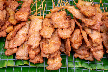 Fried Pork stick on grid market, Thai cuisine traditional signature street food (selective focus)