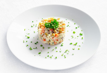 olivier salad with mayo and chicken decorated with parsley