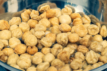 Fried fish ball in the big pan for sale in street foods market