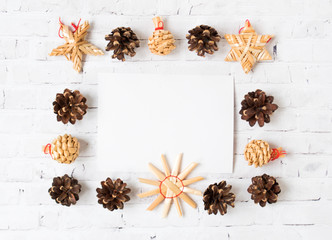Festive Christmas frame of cones and straw toys