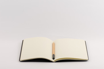 open blank copybook with pencil - writing and learning concept