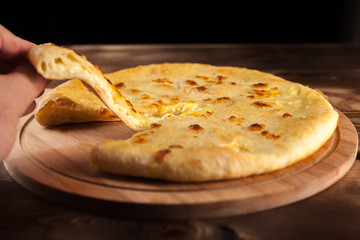 Georgian traditional food khachapuri on the wooden dish