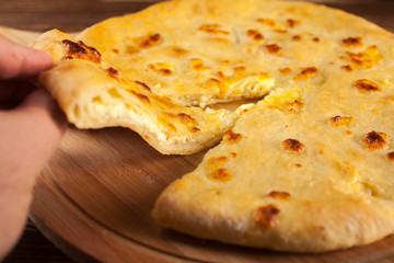 Georgian traditional food khachapuri on the wooden dish