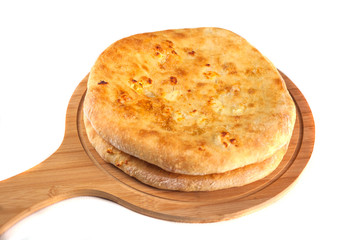 Georgian traditional food khachapuri on the wooden dish on white background