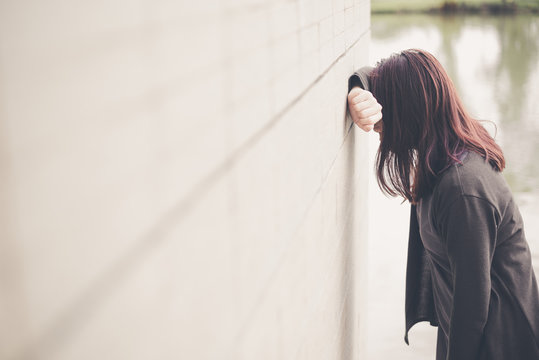 Asian Woman Sitting Alone And Depressed,Portrait Of Tired Young Woman. Depression