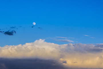 clouds on blue sky background with moon
