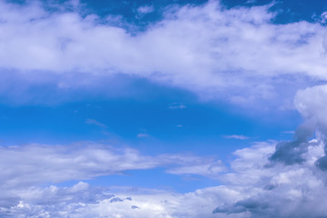 grey stormy clouds on blue sky background
