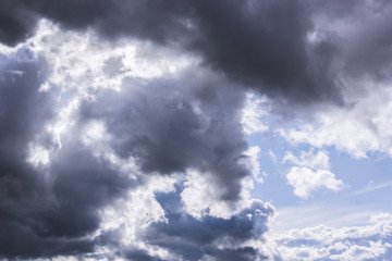 grey stormy clouds on blue sky background