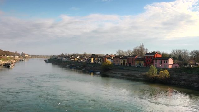 flowing waters of the Ticino river near colorful houses in Pavia in Italy