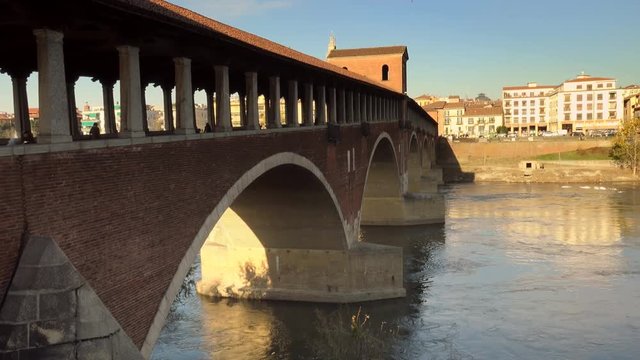 covered bridge  over the flowing waters of the Ticino river  in Pavia in Italy