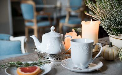 Evening tea with rosemary and grapefruit, by candlelight in a vintage cafe