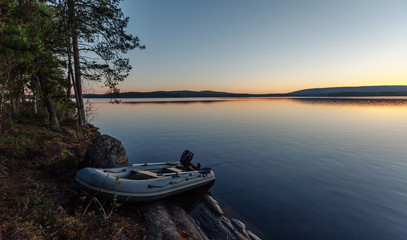 Fishing boats near the lake at sunset.