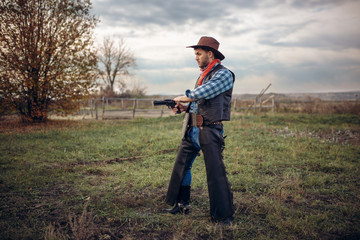 Brutal cowboy with revolver, gunfight on ranch