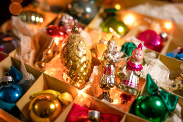 Old glass toys, balls and decoration for the Christmas tree on the paper box. New Year theme