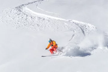 Foto op Canvas freeride skier skiing downhill through deep powder snow © Marcin