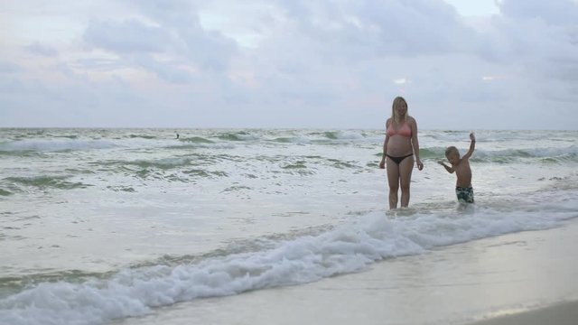 Young Mother and Her Son are Walking on the Beach Along the Seashore USA 4k